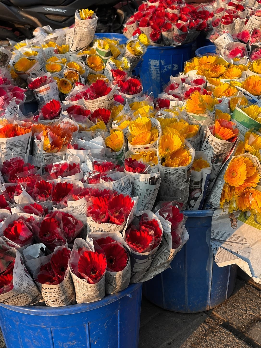 Fresh flowers at the wholesale market — gerberas and roses wrapped in newsprint